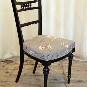 An ebonised aesthetic movement side chair in grey-mauve embroidered silk