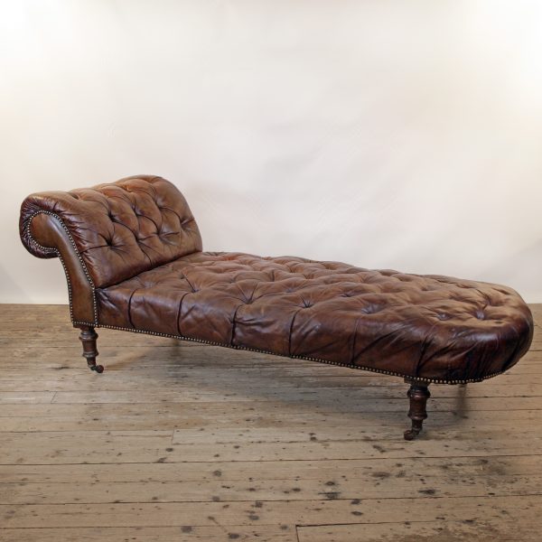 A Victorian buttoned brown leather chaise longue, by Cornelius V Smith