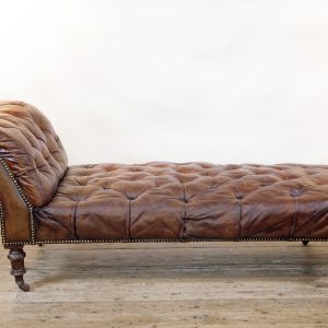 A Victorian buttoned brown leather chaise longue, by Cornelius V Smith