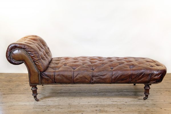 A Victorian buttoned brown leather chaise longue, by Cornelius V Smith