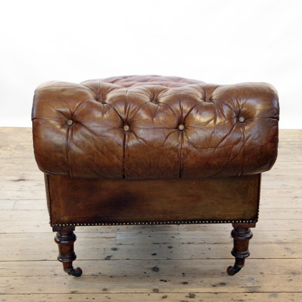 A Victorian buttoned brown leather chaise longue, by Cornelius V Smith