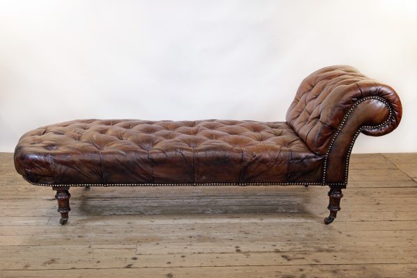 A Victorian buttoned brown leather chaise longue, by Cornelius V Smith