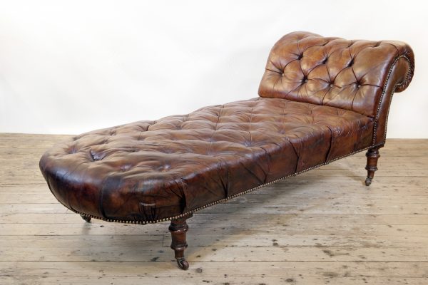 A Victorian buttoned brown leather chaise longue, by Cornelius V Smith