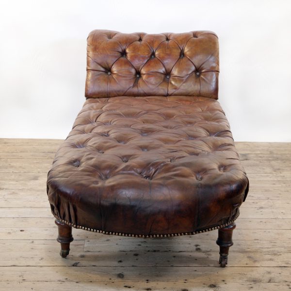 A Victorian buttoned brown leather chaise longue, by Cornelius V Smith